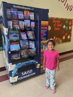Girl Smiling by the Book Vending Machine