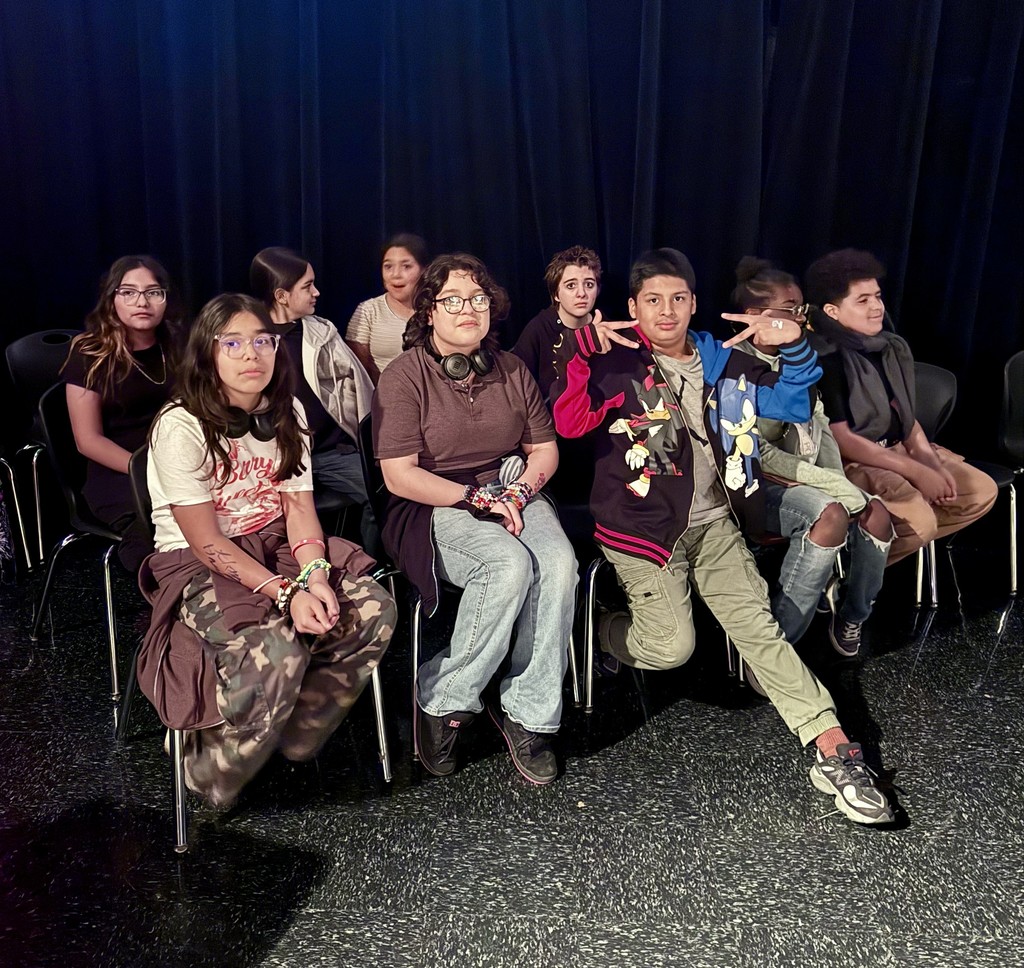 Group sitting, black background