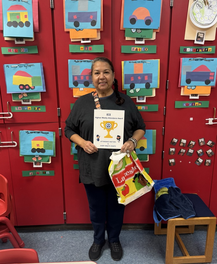 teacher holding attendance award 