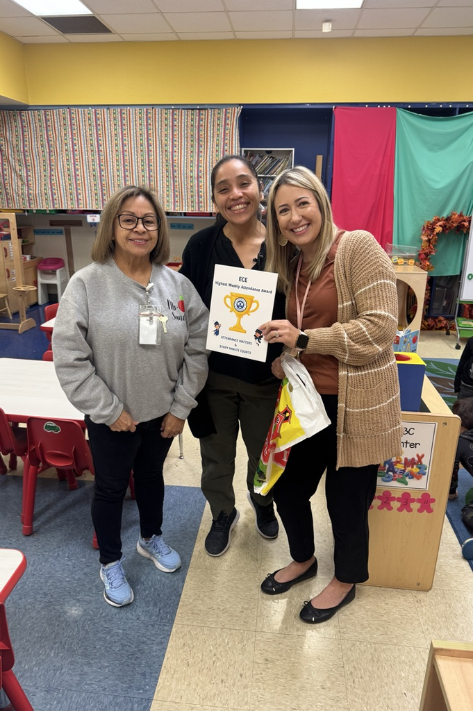 teacher holding attendance award 