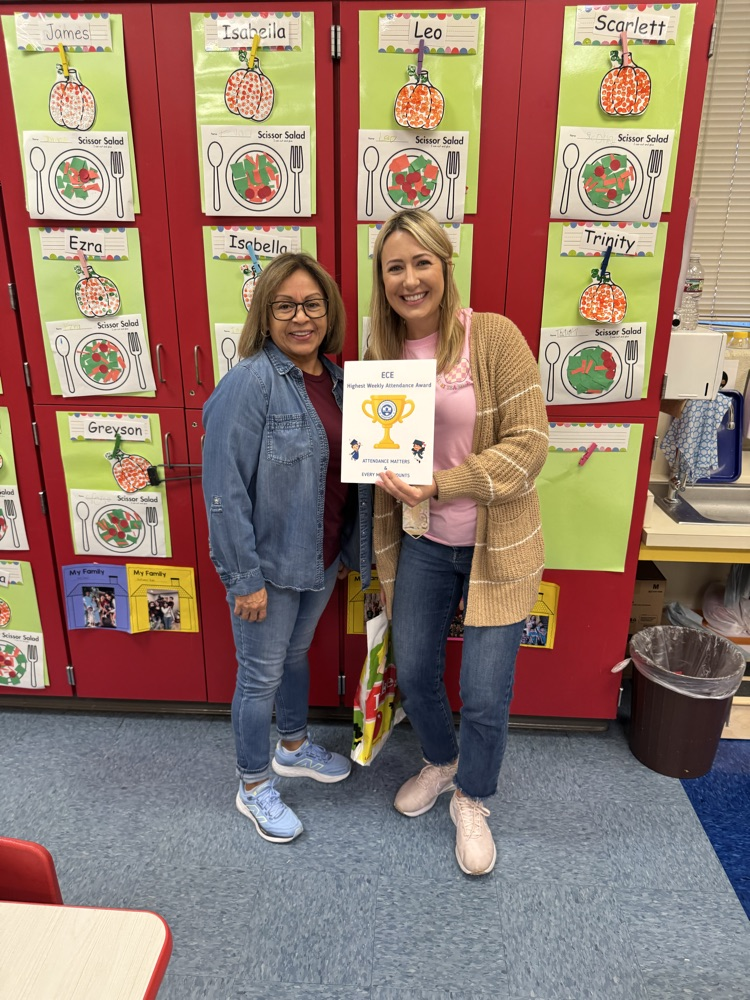 teacher holding attendance award 