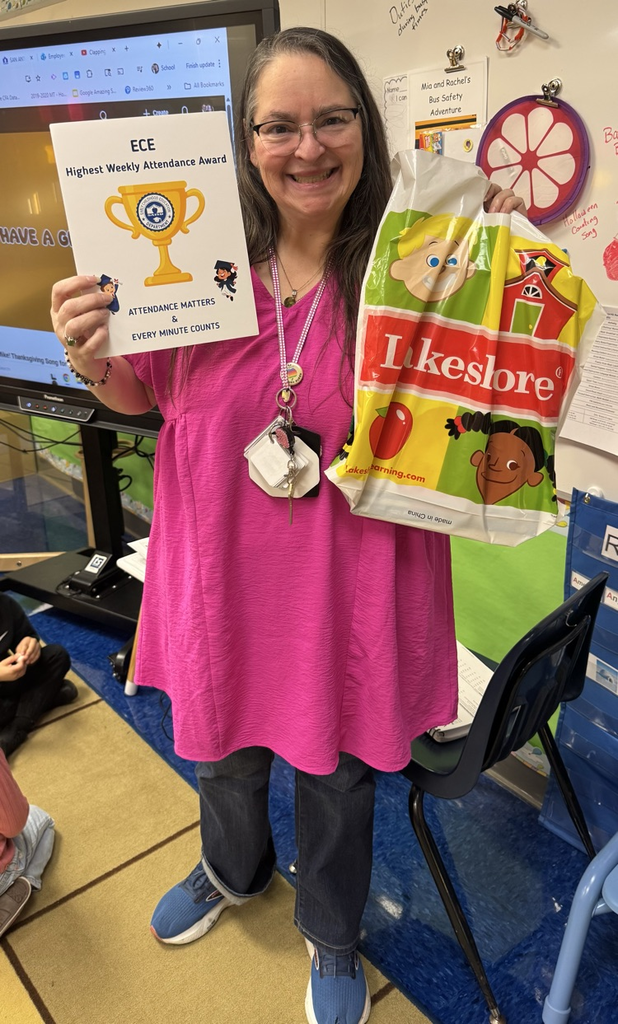 teacher holding attendance award 