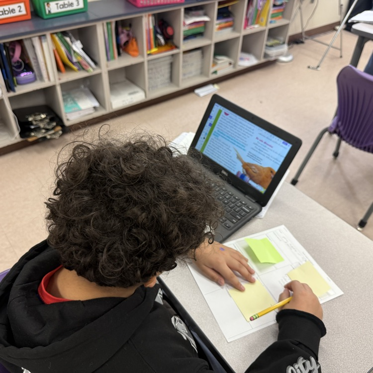 A student uses text evidence to complete their argumentative short constructed response.