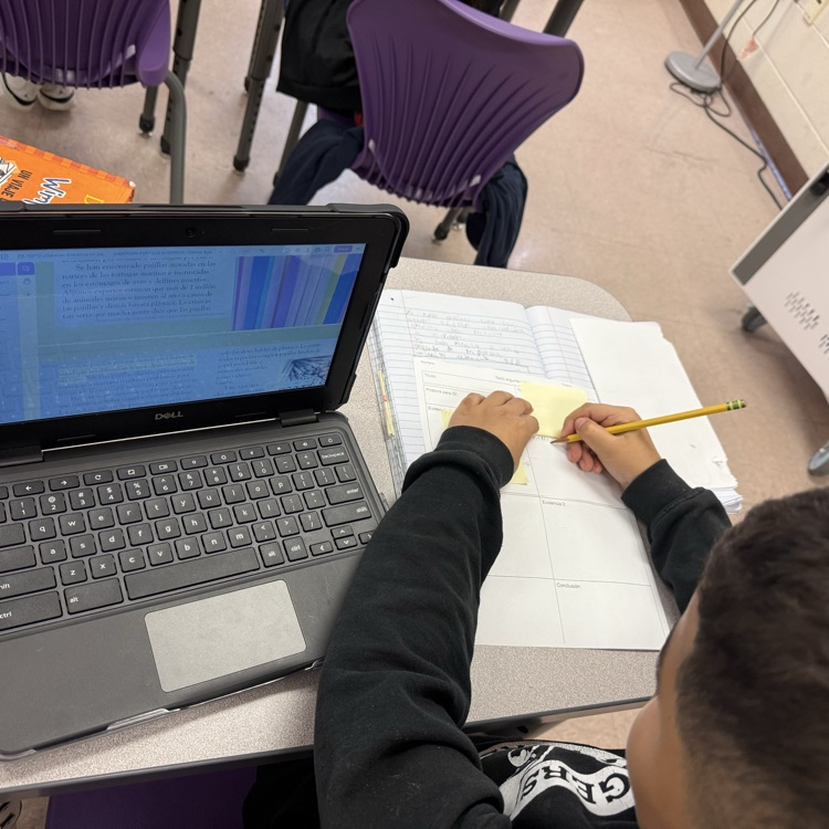 A student uses text evidence to complete their argumentative short constructed response.