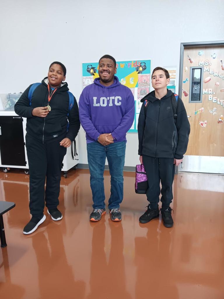 YMLA students and Coach Carter with their medal