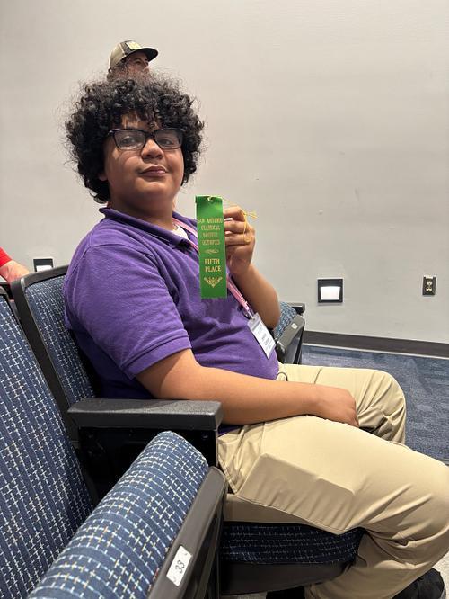 YMLA Latin club student receiving an award.