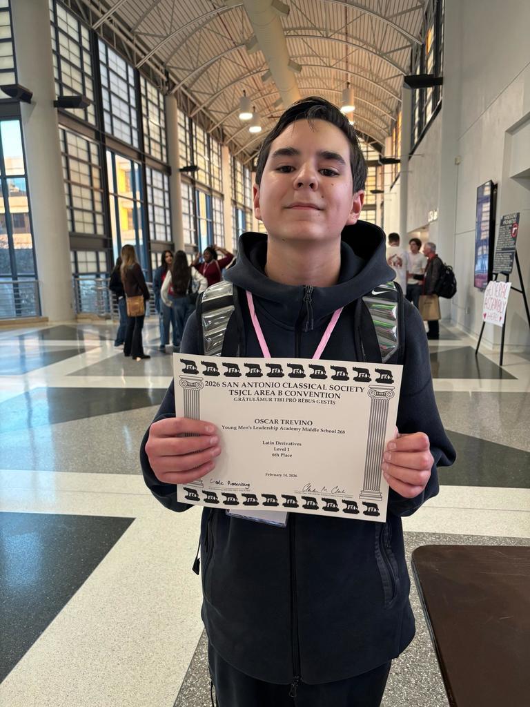 YMLA Latin club student receiving an award.