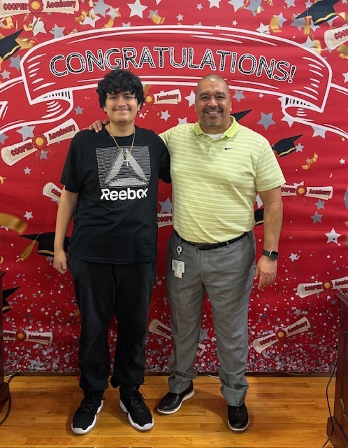 Graduate Shaun Thompson with Principal Becerra