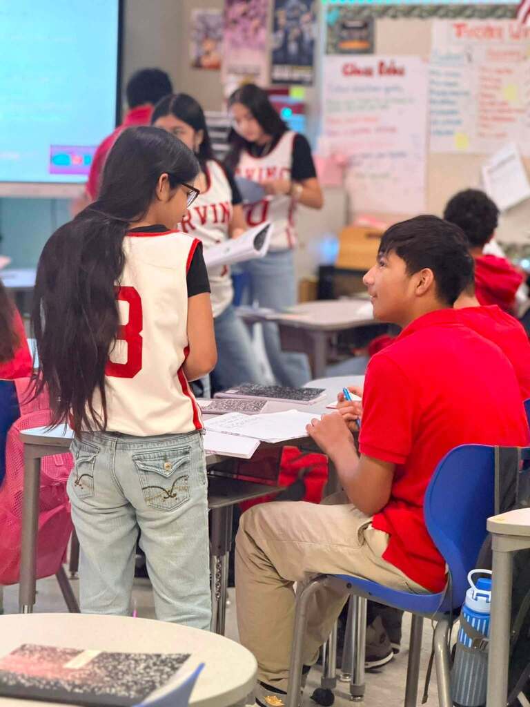 female student explaining math to another male student