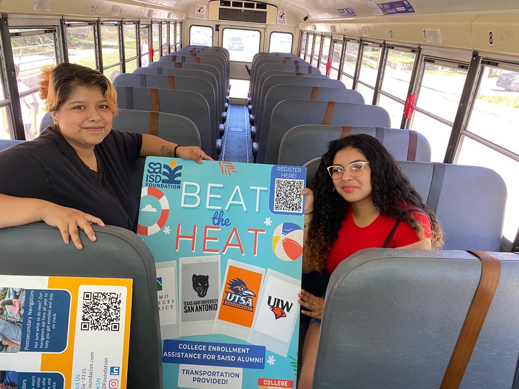 girls on bus holding poster