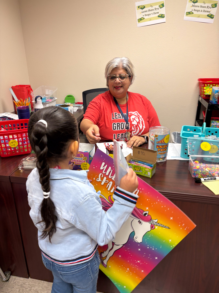 girl with poster at teachers desk
