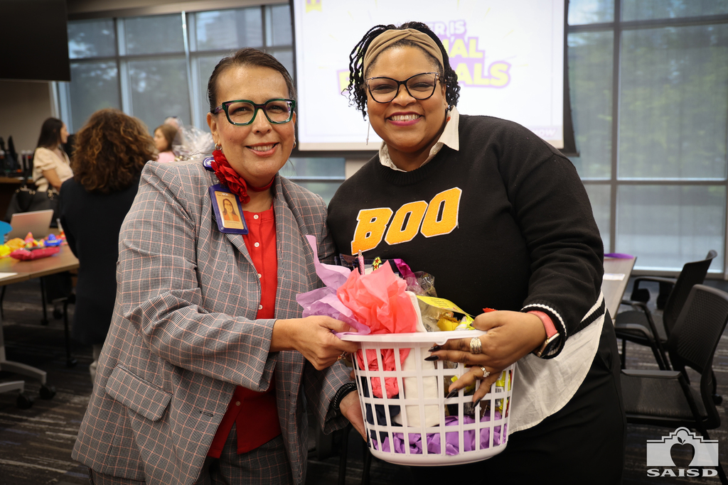 2 women holding a gift basket 