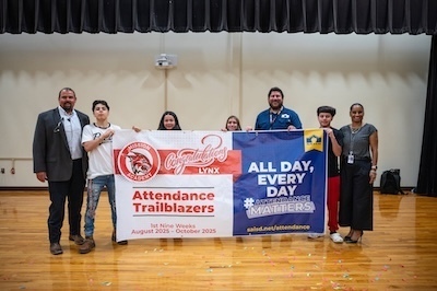Mission Academy students, principal, board member hold Trailblazer Banner