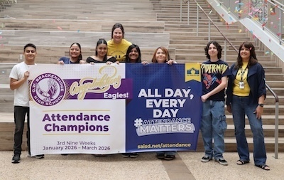 Brackenridge High School students and principal hold Attendance Champion banner