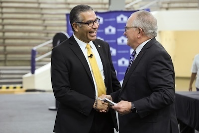Two men shake hands