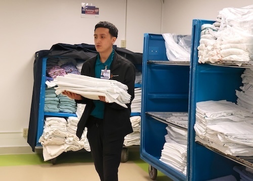 Intern carries towels