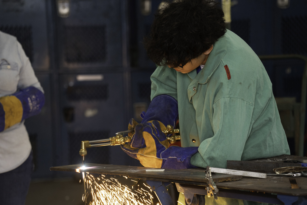 SDHS Freshman, Adrian Gonzalez, demonstrates metal cutting with an acetylene torch. 