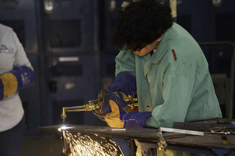 SDHS Freshman, Adrian Gonzalez, demonstrates metal cutting with an acetylene torch. 