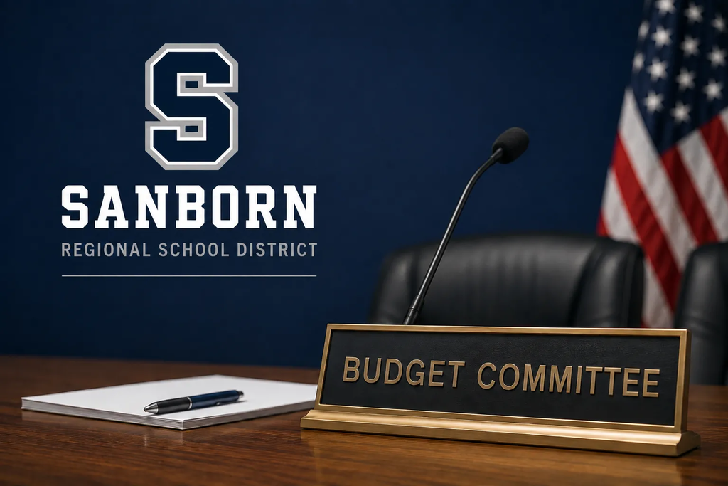 Budget committee stock photo with sanborn district logo, pen and paper on desk and a name plate that says budget committee