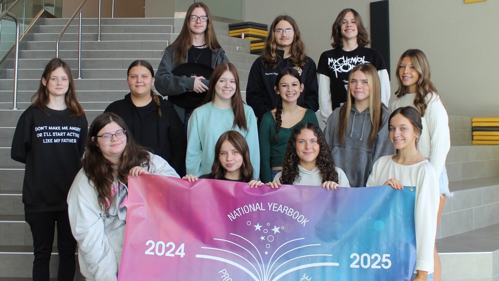 Group of students holding banner for national yearbook recognition
