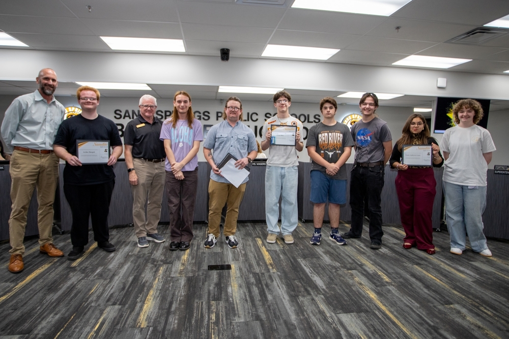 High school Speech and Debate students receive certificates of recognition from school officials and school board members.