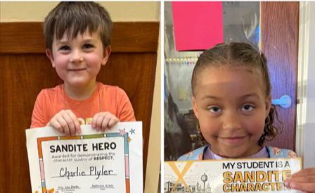 Two students, Charles Plyler and Ariella Harris, smile while holding their Sandite Hero awards for showing respect.