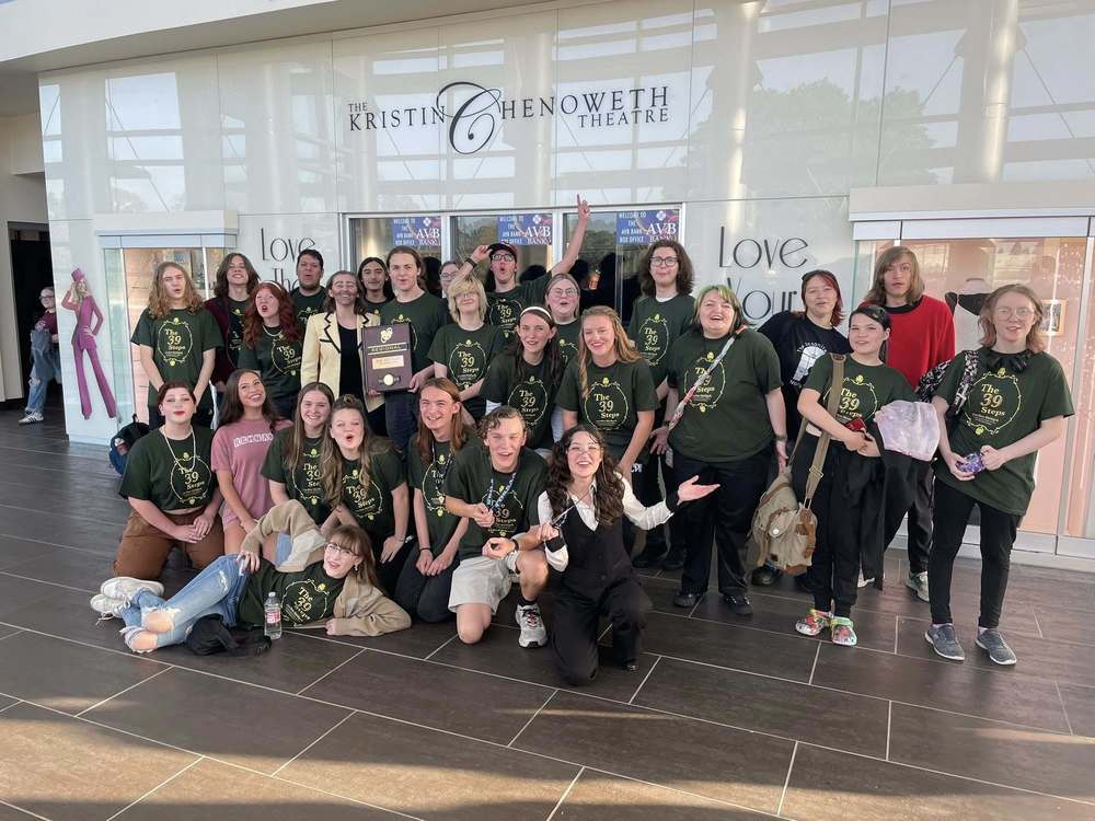 A large group of drama students pose for a photo. One student is holding a plaque that reads "Regional One-Act Play Champion Class 6A 2025"