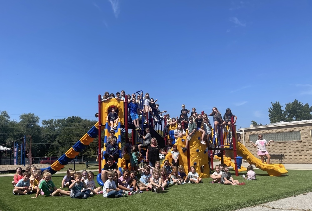 Kinder & 5th grade students on new playground structure