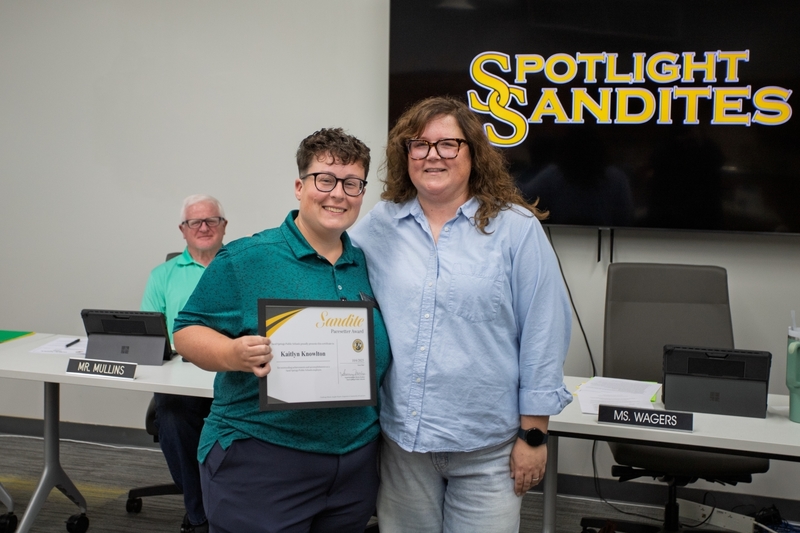 Kaitlyn Knowlton smiles next to board president Whitney Wagers and receives the Sandite Pacesetter Award