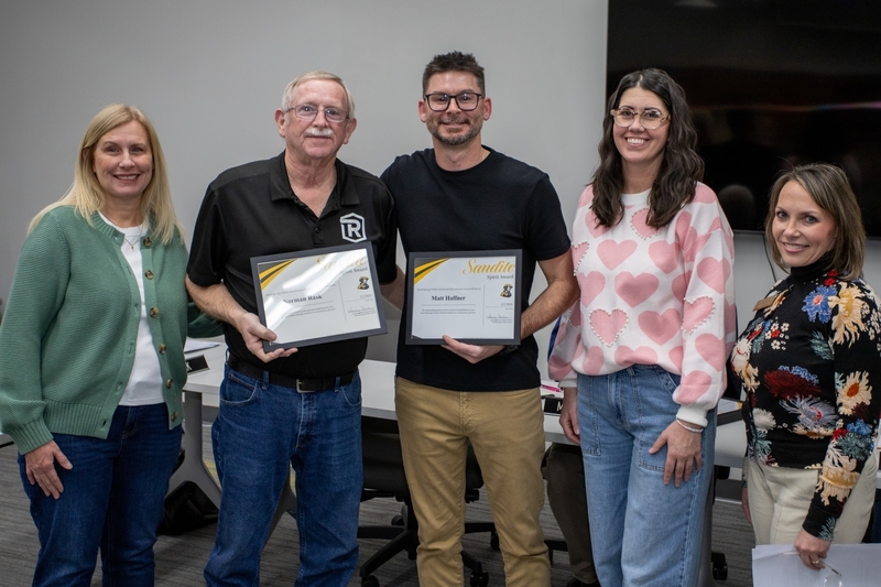Matt Haffner and Norman Rask receive certificates of recognition from administrators and the board of education