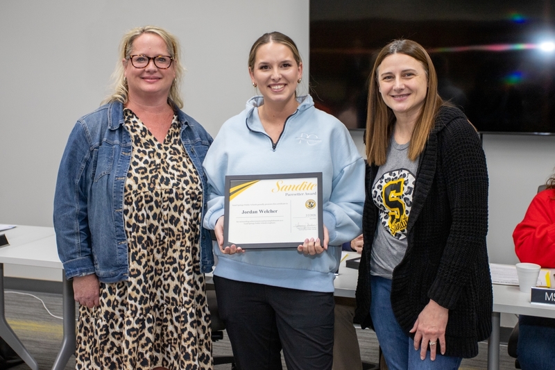 Jordan Welcher receives certificate of recognition from administrator and board of education