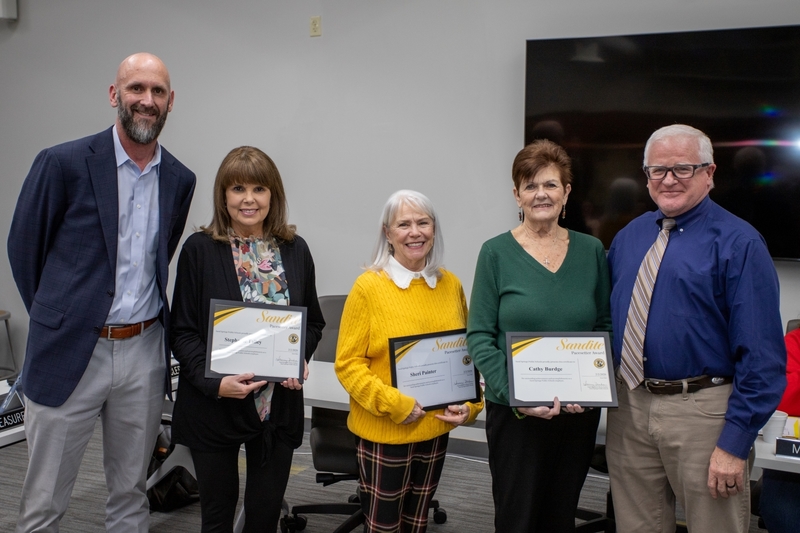 Attendance clerks receive recognition certificates from the board of education