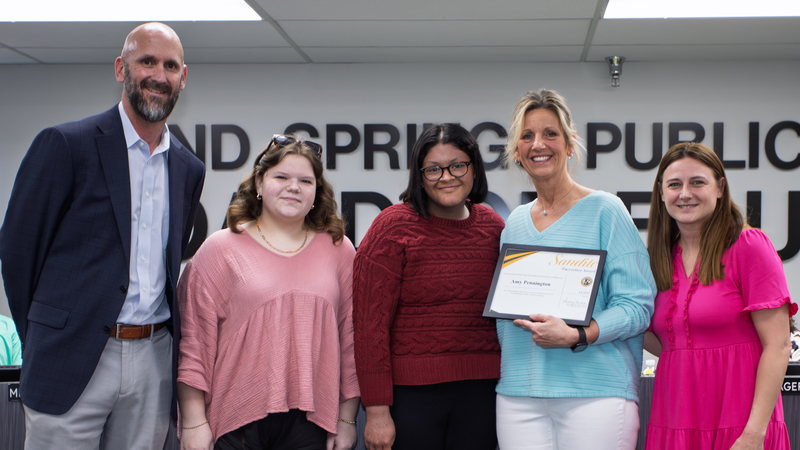 Media specialist Amy Pennington receives certificate of recognition from school administrators.