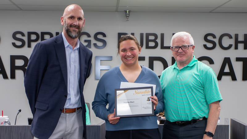 Student Sophia Hart receives certificate of recognition from Charles Page High School administrator and Sand Springs Public Schools board member.