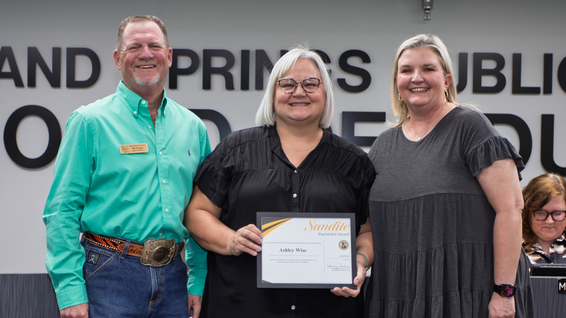 Ashley Wise receives certificate of recognition from SSPS board member and school staff.
