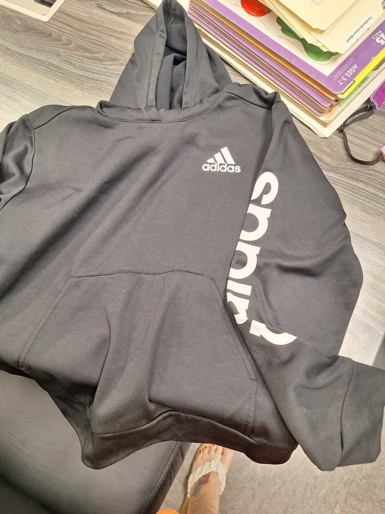 Black hoodie with white Adidas lettering