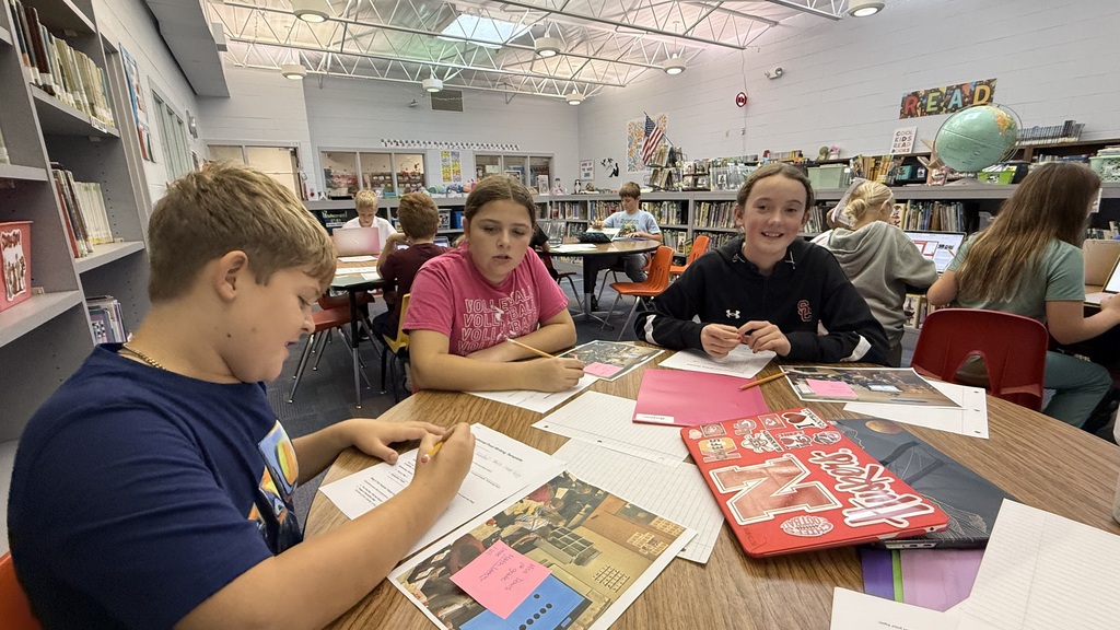 Students writing social media posts.