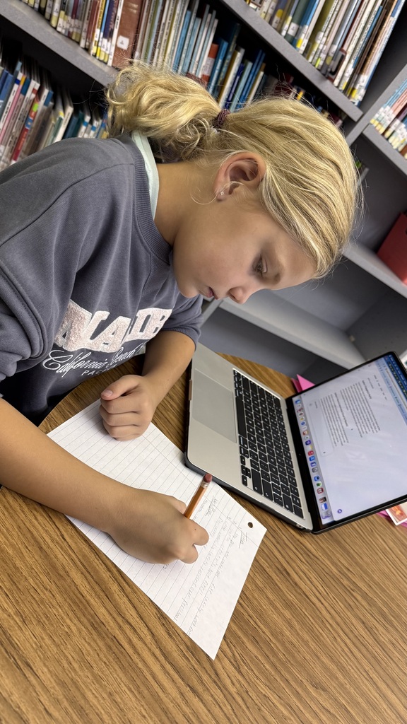 Students writing social media posts.