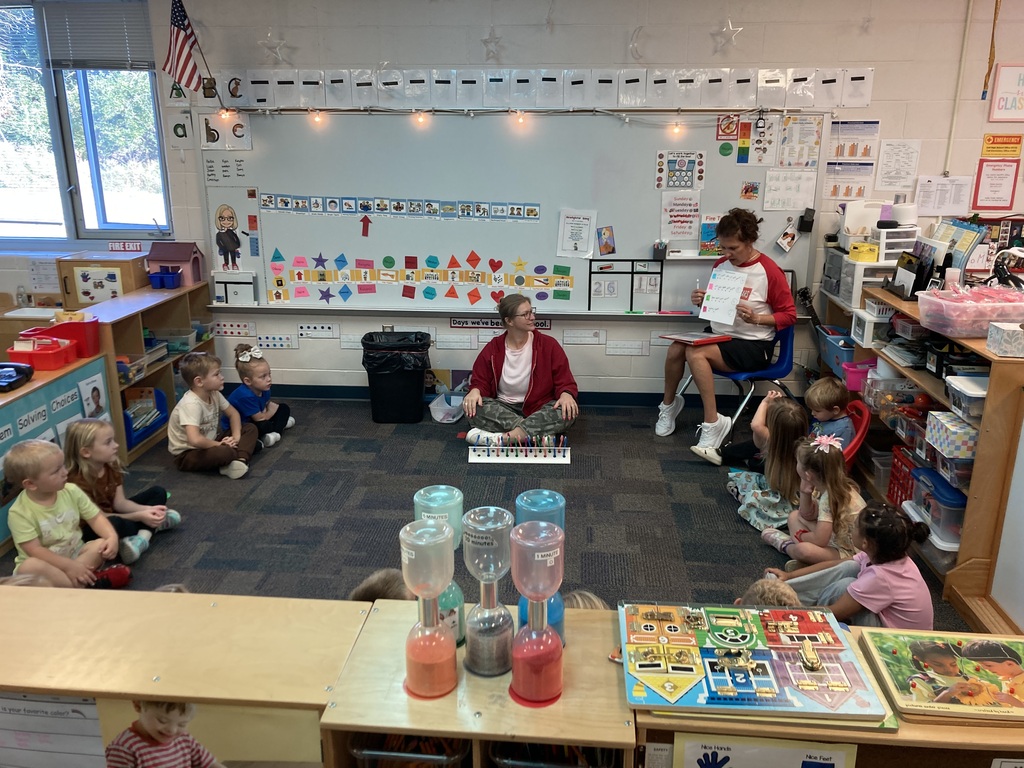 Students at circle time charting tooth brush colors.