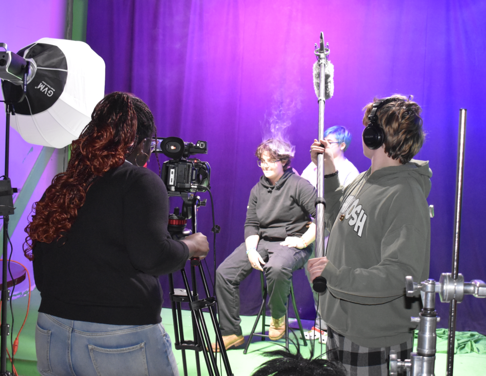 This is part of a series highlighting the career and technical education programs offered at Sanford Regional Technical Center. Behind professional cameras and editing software, students in Sanford Regional Technical Center's Video Production program transform creative ideas into award-winning digital mediaāone frame at a time. Instructor James Harmon, with over twenty years of independent film production experience, brings real-world expertise directly into the classroom. Beyond his work as a video contractor, he founded and directed a successful film festival for five years and has taught in Sanford for nearly twenty years. That real-world experience shapes a classroom culture where students feel genuinely connected to their work and each other. "My favorite part of Video Production is that it's the only class I have where I feel really connected to the other students there beyond just sitting in the same room for a while," said Jasper Sweet, a second-year student from Sanford High School. "We make some really cool stuff together, and it wouldn't work if we didn't bring all the creativity and ambition we have to the table." That creative energy is exactly what Harmon values most. "I've learned that they're an endless well of ideas, inspiration, and entertainment," Harmon said. "All I need to do is show them a few things, and they're off to the races, surprising me with their creativity, determination, skills, and talent." Students learn essential roles in television, digital cinema, and audio production, working as individuals and in teams operating professional equipment and using industry-standard software to bring their ideas to life. The program prepares students for professional opportunities through the Maine Association of Broadcasters Video Production Certification. They can earn college credits through Southern Maine Community College. The program's excellence was on full display at this spring's SkillsUSA state conference. Of the twelve SRTC students who participated, six earned medals, creating award-winning TV ads, short films, audio broadcasts, and computer-generated animations. "I'm so proud of my current media students and graduates," Harmon said. "Every student put their best foot forward.ā Harmon emphasized the broader lessons students take from the program. "Video production is an engaging, meaningful experience," he explained. "Students get to seeāand come to knowāhow every person on a team is essential, and how impactful their voice can be in a group. The teamwork, the give and take, and the compromises that they make in two years of video production helps prepare these students for all of the interpersonal communication that will be important in their future." SRTC second-year student from Kennebunk High, Winter Nodden, highlighted the program's resources and career potential: "My favorite aspect of the program is the sheer aspect of creative opportunity and money that has been provided to us for this school. While we can't have everything, Mr. Harmon has so much knowledge as a teacher and there are so many different jobs that could come from this class." The program extends beyond the classroom through successful internships with The Sanford Mainers and Seacoast Oldies, giving students real professional experience.