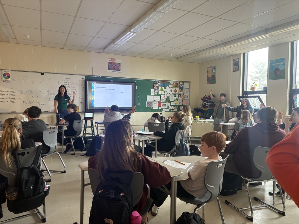 Sanford Middle School's 7th grade students participated in the school's annual Junior Achievement in a Day event on Wednesday, April 15, bringing together community volunteers and students for a day of hands-on financial literacy learning. Volunteers came in to teach lessons about personal finance, drawing on their own professional experiences to bring the material to life. As Social Studies Department Chair Erin Barry noted, "The volunteers work for various local businesses and share their work experiences and knowledge about money management with students." Organizations represented included Machias Savings Bank, Kennebunk Savings Bank, Atlantic Credit Union, the Sanford Chamber of Commerce, Longfellow Hotel, and Moody's Collision. This year's program, Economics for Success, guided students through four key lessons over the course of the day. Rotating through sessions with a different volunteer for each, students learned about budgeting, the role of credit, how to pay for wants and needs, and how to plan for future income. One highlight came from Cari Qatar of the Sanford Chamber of Commerce, who led the Managing My Money unit. Her session drew creative parallels between managing time and managing money, sparked lively discussion about needs versus wants and short-term versus long-term goals, and got students thinking about their own financial futures. "The kids did a great job brainstorming ways middle-schoolers can earn money," Cari said. "They walked away realizing that making many small purchases add up and could affect their ability to buy something more meaningful down the line." Danielle Moody of Moody's Collision, who led the Planning For My Future Income unit, spoke to the lasting impact of the program. "Kids do look back on this learning opportunity and realize how important financial literacy is," she said. "Even though these sessions are only 45 minutes long, I do think the students take away a lot from them. It's really nice to share some of that terminology and help them understand." Junior Achievement in a Day is a wonderful example of what becomes possible when schools and their surrounding communities come together. Hearing directly from working professionals helps make financial concepts feel real and relevant in a way that goes beyond the classroom. A special thank you goes out to all of the volunteers, the teachers who helped organize and host sessions, and the Sanford Middle School staff who worked behind the scenes to make the day run smoothly.