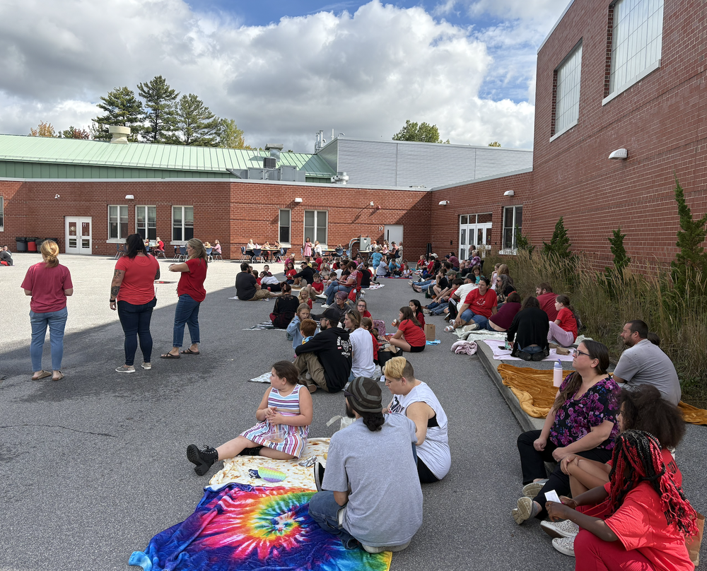 Margaret Chase Smith Elementary School hosted its first-ever "Lunch with a Loved One" event last Friday, bringing families together for a celebration of community and connection. An impressive 71% of families joined in, making the picnic burst with smiles, laughter, and special moments. Families and friends arrived with picnic blankets and lunches ready to share quality time with their students. As a special reward for reaching 100 positive referrals, Principal Hallisey and Assistant Principal McGuckin wore their pencil costumes at lunch. They will continue to wear them to boost their theme this year and reward students for their hard work. Each grade level had a dedicated half-hour lunch period to spend with their families. Student Den ambassadors helped direct students to their loved ones, and families checked in with staff to make the event run smoothly. When asked about their favorite part of the lunch, one of the den ambassadors summed it up perfectly: "We’re having fun and spending time with family."  The feedback from families was overwhelmingly positive, with many sharing, "We'd like to do this in the spring too!" This event was a beautiful way to promote family engagement and create lasting memories