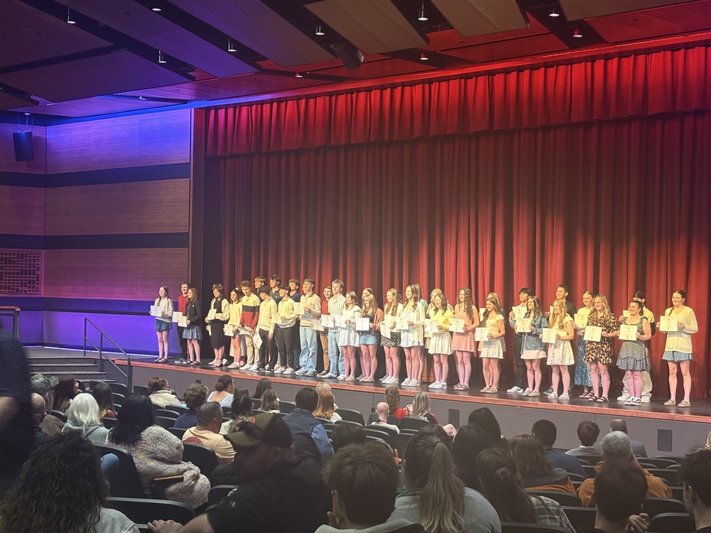 Sanford High School's Performing Arts Center was filled with student-athletes, families, and coaches Monday evening as the school celebrated its winter athletic season at the annual Winter Athletic Recognition Night. Sanford Athletic Director Zach Lemelin opened the evening with a reflection on what the night meant for the athletic department. “The Winter Awards Night was a great night, which highlighted the success of our individuals and teams at Sanford High School,” Lemelin said. “I am extremely proud of our student-athletes and coaches for a successful season, and it’s a perfect way to wrap up the winter.” Several Spartans earned individual conference and state honors. On the girls basketball side, Mollie Puffer was named SMAA First Team All and selected as the program’s Most Outstanding Player, while Paige Sevigny earned SMAA Second Team All honors and Jaslinn Johnson was named to the SMAA All Defensive Team. Dylan Gendron led the boys basketball program with SMAA First Team All honors and the Most Valuable Player award, with Luke Gendron earning SMAA Third Team All and Ryan Alexander receiving an SMAA Honorable Mention.  In indoor track, junior Mattea Peters had an outstanding season, earning All State Second Team recognition in the 400m dash and SMAA First Team honors in the 200m dash, 400m dash, and high jump. Competition cheer’s Mariah Provencher was named SMAA First Team. Dozens of student-athletes earned spots on the SMAA All Academic Team by maintaining a cumulative grade point average of 92.5 or higher, with honorees representing girls basketball, boys basketball, indoor track, swimming, competition cheer, wrestling, and both co-op ice hockey programs. The evening also highlighted the school's Leadership Council program, which met weekly throughout the winter with mental performance coach Megan Hamilton of Stride Mental Performance. Athletes who participated across multiple seasons received special recognition, notably Isabella McCall, who was honored for her commitment as a four-time member of the council, the highest level of recognition in the program One highlight of the evening was the recognition of two coaches. Rossie Kearson was named SMAA Girls Basketball Coach of the Year after leading the Spartans to a 16-2 regular-season record, a perfect 9-0 home record, a second-place league finish, and a run to the Class A South semifinals. John Morgan was recognized as the Maine Basketball Coaches Association Class A South Coach of the Year, leading the boys team to a 17-1 regular-season record and an appearance in the Class A South semifinals. The night also recognized several Sanford student-athletes who competed through co-op programs this winter. Kenzie Provencher joined the Biddeford/Wells/Kennebunk/Sanford girls ice hockey team, contributing an assist on a double-overtime playoff-winning goal as the team finished 13-5 and reached the semifinals. Drew Vessels, Carter Wood, and Max Lapointe represented Sanford on the Marshwood/Traip/Noble/Sanford co-op boys hockey team, while the Sanford/Marshwood/Massabesic co-op swim team, which doubled in size this season, sent Sanford’s Katie Szymbor to the state meet. Coaches from each program took the stage to reflect on their season and recognize standout athletes with special team awards for leadership, improvement, and dedication. (Click here for a complete list of Sanford award winners.)