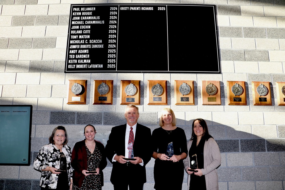 Sanford High School inducted five new members into its Athletics Hall of Honor on Saturday, November 29, during a ceremony at the Performing Arts Center that recognized decades of athletic excellence and community impact. Keynote speaker David Woodsome (Class of 1965) opened the afternoon ceremony with a message about the ripple effects of kindness in athletics. Woodsome reflected on the moments that shaped his own athletic journey. He recalled the coaches who encouraged him to try football, families who gave him rides home, and community members who helped him get contact lenses so he could fully participate. "Be grateful, pay it back and pass it on," he said. "Each one of you can reach out to someone who hasn't yet had that chance." The Class of 2025 inductees represent decades of Sanford athletic excellence spanning from the 1950s through the 1990s. Andy Adams (Class of 1978) helped lead the Sanford baseball team to the 1978 Maine State Class A championship and finished with a career record of 17-5 as a pitcher. Adams signed with the Chicago Cubs in 1982. Theodore "Teddy" Gardner (Class of 1957) earned 14 varsity letters across four sports and later was inducted into the Maine Sports Hall of Fame in 2005. Keith Kalman (Class of 1964) helped Sanford's wrestling team win three straight state championships and later returned to coach the program to three more state titles. Kelly Nobert LaFountain (Class of 1984) became the first female from Sanford to earn a Division 1 basketball scholarship. Kristy Parent Richards (Class of 1994) excelled as a three-sport athlete before coaching Sanford's girls basketball team to the 2006 state championship. Richards currently serves as the assistant principal at Carl J. Lamb Elementary. Adams, LaFountain and Richards attended the ceremony in person. Loved ones accepted honors on behalf of Gardner and Kalman, who have passed away. Teddy Gardner's granddaughter Brenna spoke about what the recognition meant to her family, while Janet Kalman offered heartfelt reflections on her husband's lasting impact as a teacher, coach, and mentor. Don Campbell's tribute to his lifelong friend Keith Kalman captured what the Hall of Honor ultimately celebrates. "His achievements in life and who he was as a person were all taught in a school of athletics," Campbell said. "His strength, his unselfishness, his loyalty—those were the qualities that made Keith an exceptional athlete and an even better person." Adams, Richards and LaFountain each expressed gratitude for coaches, teammates, and families who made their success possible. LaFountain offered advice to today's student-athletes: "Never give up on your dreams, embrace the hard work, and cherish every moment. The memories you make with your teammates will last a lifetime." The ceremony also recognized the Red & White Foundation, a nonprofit booster group that has been an integral part of Sanford High School athletics for over 25 years and serves as the Hall of Honor's primary financial partner.