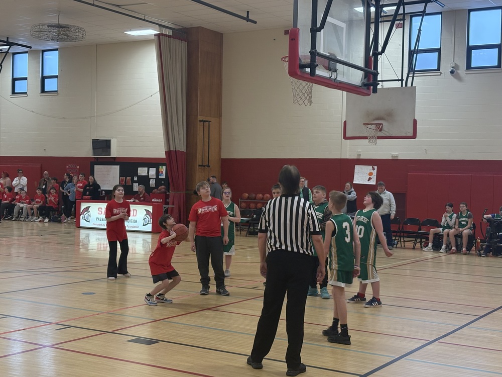 Sanford Middle School reached a historic milestone recently, hosting its first-ever Unified Basketball scrimmage.   Unified Sports is a Special Olympics program that pairs students with and without intellectual disabilities as teammates. This is the program's first year at Sanford Middle School. The team practiced once a week, with 17 athletes and 11 partners, 28 participants in all, spanning grades 6 through 8.  Sanford’s scrimmage against Massabesic Middle School was the team's first time competing, with Massabesic edging out a close 82-80 win. Massabesic accepted the invitation to play after school administration reached out to neighboring schools, and their coach provided valuable guidance as coach Meagan Collupy worked to get the program off the ground.  Collupy said the effort involved coordination with administrators, Special Olympics Maine, life skills teachers, service providers, wellness teachers, and school counselors.   "I was a little nervous going into game day, but then actually seeing it unfold, I was like this was awesome," said Collupy. "Talking to some of the other staff members, they said it was hard not to cry watching it, seeing the crowd and the families."  Sixth grader Blake Russell said the atmosphere on the court captured what the program is all about. "Everyone was happy for everybody," he said.  Collupy shared that sentiment. "Two partners walked by the morning after the game and said, 'Why does it have to be over? Why can't we still practice?'" she recalled. "That was actually the sweetest thing I'd heard."  Principal Joe Mastraccio credited the work of several staff members in getting the program launched. "Sanford Middle School's Unified Basketball program was many years in the making. This year, we were able to get it off the ground. Meagan wrote a proposal that included equipment, staff oversight, practice and game logistics, and athlete/partner requirements. Many meetings later between Meagan, Sanford Middle School Athletic Liaison Josh Allen, and Joe Mastraccio, in collaboration with SHS Unified coach and Special Education Teacher Stephanie Boisonnault, we were given the green light by SHS Athletic Director Zach Lemelin to have a pilot year to see the interest in the program, and it really took off!"  Lemelin echoed that enthusiasm. "The opportunity for our middle school student-athletes to participate in and experience a unified basketball game will be one of the best things that happens in the Athletic Department this year," he said. "It is a special event that I hope will continue, and I appreciate having dedicated staff and coworkers willing to give our students a great experience."  The future of the program looks bright. Lemelin has already approved Unified Basketball as an official winter sport next year, with a full schedule of regular games against other middle schools. Fellow sixth grader Luke Levesque is already looking ahead. "Next year we're going to have a full season. We're very excited about that," he said.  In the meantime, the team plans to continue building connections through activities like lunch buddies and outdoor play as the weather improves.  "We're really happy to have it here," Collupy said. "We're very excited it all worked out."