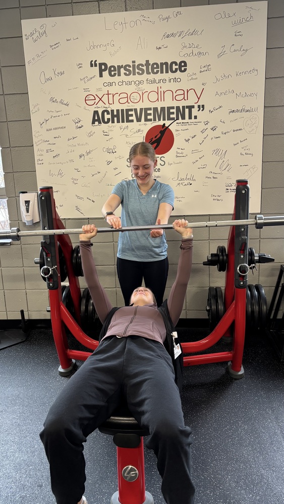 When Sanford Regional Technical Center launched its new Sports Medicine Program, it opened a door that one Sanford High School senior was ready to walk right through. Now a senior with plans to study exercise science at St. Joseph's College next fall, Isabella McCall has become one of the program's standout participants, pairing her classroom learning with a hands-on internship at Maine Health's Sports Performance Center in Sanford. Isabella admits she wasn't always sure what direction she wanted to take after high school. It was through conversations with teachers and some soul-searching that exercise science started to feel like the right fit. When she spotted the Sports Medicine Program, she jumped, though not without some self-doubt about whether she could handle the realities of a medical setting. "I just was like, no, I'm just going to go for it," she said. "The program was a great way for me to see if I can handle injuries and stuff like that. And it's been good so far." The program had originally been two years, which gave her pause as a senior, but when it was condensed to one year the decision became easy. "And then they switched it to one and I was like, I'll do it," she said. Through the program's Extended Learning Opportunities, Isabella arranged an internship at Maine Health's Sports Performance Center, where she spends two to three days a week observing treatments and supporting staff.  The classroom curriculum, covering muscle anatomy, health terminology, and movement mechanics, has translated directly to the gym floor. At the Sports Performance Center, Isabella observes treatments, helps explain exercises to clients, and occasionally sets up workouts under the guidance of staff. She recalled one moment when a client was working through an exercise involving internal rotation with one arm and external rotation with the other. "The person was like, 'I have no clue what this is,'" Isabella said. "And I said, ‘I bet it's going to be like this,’ and then the strength and conditioning specialist demonstrated and it was exactly what I was thinking." A three-sport athlete currently running outdoor track, Isabella has a natural connection to the field and it hasn't gone unnoticed. Her instructor and track coach, Jess Giordano, says it has been "truly an honor" having Isabella in the program, pointing to her outstanding academic performance and her ability to bridge the gap between classroom learning and real-world application. What stands out most, though, is the effect she has on those around her. "She leads by example and her peers gravitate to her insights because she demonstrates how to think critically and problem solve things that may be encountered in the field," Giordano said. "I am excited to see what her future brings." 