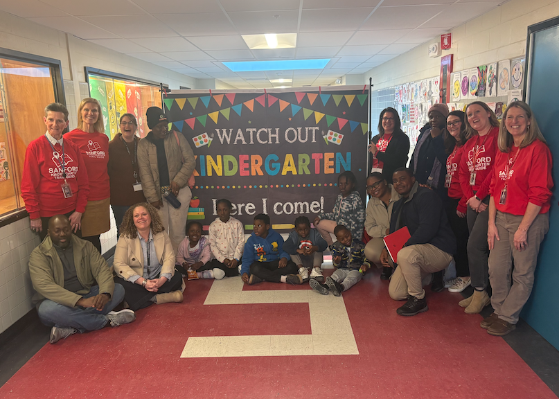 The Sanford School Department hosted its second District-Wide Kindergarten Registration event on Wednesday, March 4th at Sanford Pride Elementary School, welcoming incoming kindergarten families from across the community. The event provided families with the opportunity to register their child for kindergarten while also connecting directly with school staff who will play an important role in their child’s school experience. Staff members in red shirts were stationed throughout the room to guide families through the registration process and answer questions. Additionally, members of Sanford High School’s new Interact Club volunteered their time to help. Parents had the chance to speak with Kindergarten teachers, administrators, school counselors, nurses, social workers, and special education staff, making it easier to ask questions and begin building relationships before the first day of school.  In addition to completing registration, families were able to learn about a wide range of resources available throughout the Sanford community. Representatives from more than a dozen local organizations attended to share information and connect with families, including MaineHealth – Partners for a Healthier Community (HEAL Team), the Sanford Backpack Program, Kids Free to Grow, United Way, Springvale Library, SSYAA, Sanford Community Adult Education (SCAE), York County Community Action Corporation (YCCAC), Head Start, Kids Kove Childcare and Learning Center, Curtis Lake Church Early Learning Center, YMCA, and all three Sanford elementary school PTAs. The Sanford School Department thanks these community partners for helping make the evening such a valuable experience for families. Children were also welcomed into the event, enjoying a snack provided by the school nutrition team and leaving with a book from Sanford’s 10 High Quality Book Campaign to take home, helping make the evening a positive first step toward their kindergarten experience. Families who were unable to attend registration night can still register their incoming kindergartner by calling the Sanford School Department at (207) 324-2810. Current Pre-K students are automatically registered but are always welcome to attend events like this for an early glimpse of what lies ahead. The next stop on the Kindergarten Trail is the Kindergarten Exploration on Wednesday, April 9th, from 5:00–6:00 p.m. at each elementary school, where students will have the opportunity to visit a kindergarten classroom and get a hands-on look at what’s ahead.