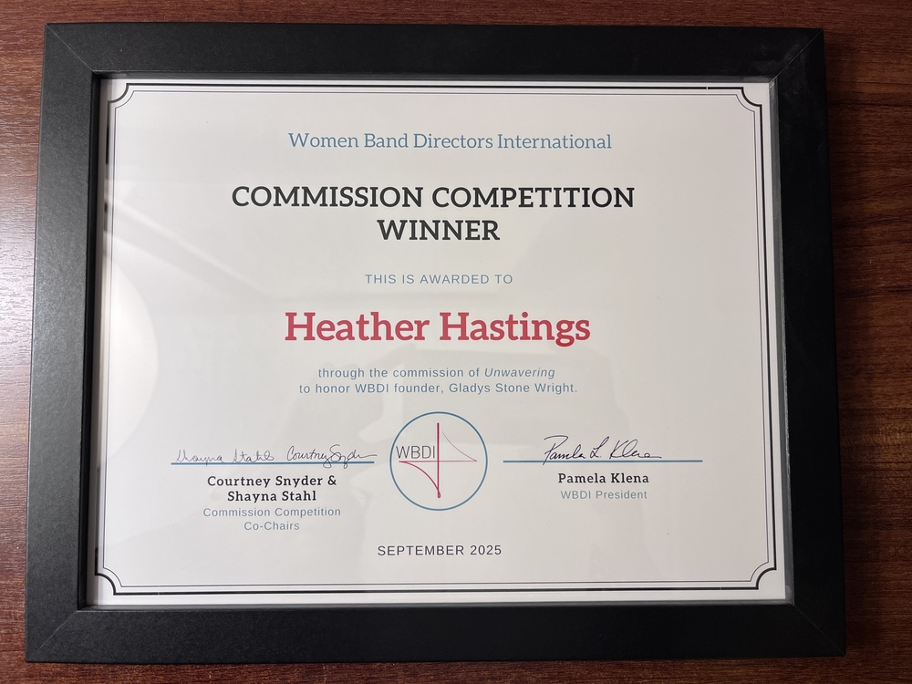  Margaret Chase Smith Elementary School music teacher Heather Hastings recently received national recognition for her work in music composition. Hastings recently traveled to Thomas S. Wootton High School in Rockville, Maryland, where her original piece "Unwavering" received its premiere performance by the school's top wind ensemble.  During her visit, she had the opportunity to work directly with the student musicians, attending their rehearsal and offering feedback on their interpretation of the work. “Unwavering” was written as a dedication to Gladys Stone Wright, one of the very first female band directors in the United States.  “For a composer, it is always a wonderful experience to have one’s music performed by a live ensemble and to hear the art come to life,” Hastings said.  At the premiere performance, she was presented with her competition award by Dr. Pam Klena, President of the Women Band Directors International (WBDI). This December, Hastings will be honored at the WBDI luncheon with a lifetime membership to the organization and will have the opportunity to showcase her compositions to band and orchestra directors from across the country.  “I am honored to receive this award and have my work recognized on a national level,” Hastings said. “The students in the Wootton Wind Ensemble gave a lovely premiere of Unwavering, and I hope that they enjoyed the performance as much as I did.