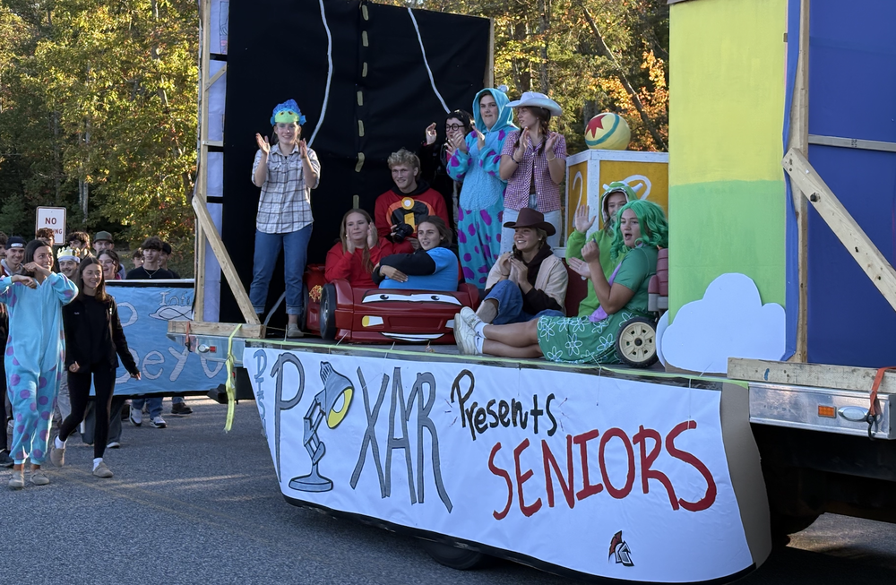 Homecoming Spirit Week at Sanford High School took place Oct. 6–11, bringing students, staff, and families together for a week of school pride, themed dress-up days, and exciting home games. Throughout the week, high school students competed grade against grade to win the spirit stick—a tradition passed down through generations of alumni. Each grade earned points by dressing up for spirit days, attending weeknight sporting events, painting large posters and crash-through banners, building floats, and participating in the parade. The celebration kicked off Monday, Oct. 6, with Adam Sandler Day, as students embraced laid-back, oversized styles. Tuesday brought the Soccer Mom vs. BBQ Dad theme, with students donning aprons, spatulas, and fanny packs. That evening, students showed their spirit at both volleyball and boys' soccer games at 7 pm, dressed in USA-themed attire. Wednesday's Disney Channel Theme Day showcased each class's creativity. Freshmen represented Disney Junior, sophomores embodied Marvel, juniors celebrated Disney Animation, and seniors brought Pixar to life. Students packed the girl's soccer game that night wearing neon. Thursday featured Red and White Day and the traditional pep rally, followed by field hockey's frat-themed home game at 6:30 pm. The week culminated Friday with the Homecoming Parade, followed by Student Council's inaugural Block Party where clubs and activities hosted vendors. The varsity football game at 7 pm drew an enthusiastic student section, where the spirit stick winner – the senior class – was finally announced.