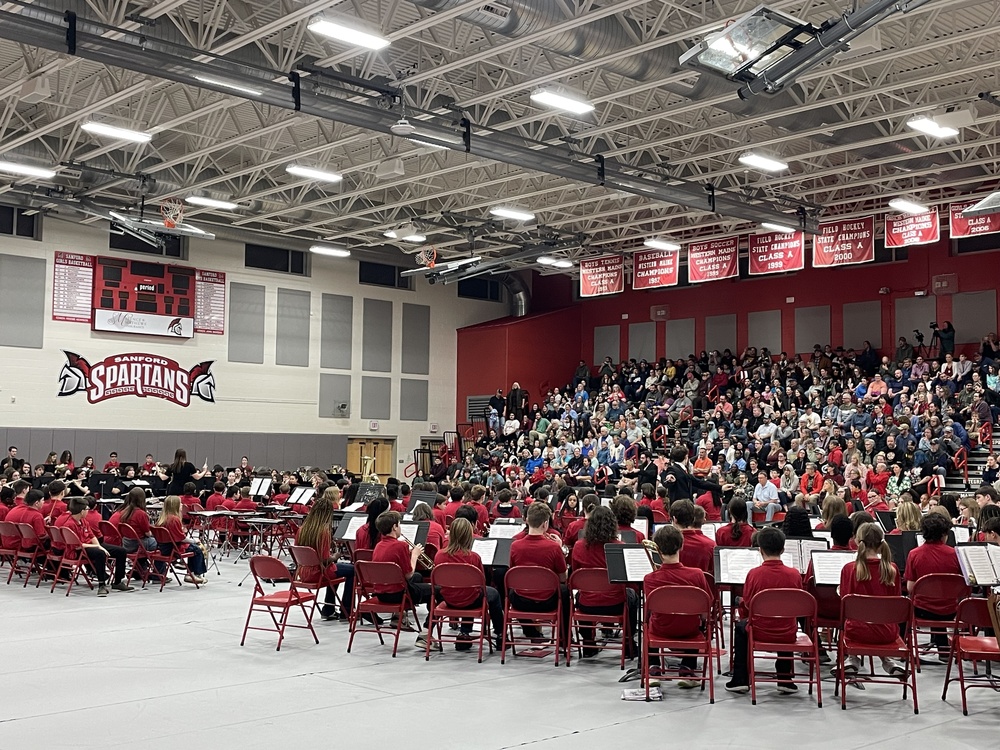 Sanford's student musicians took the stage on March 10th for the 37th Annual Sanford Band Fest, showcasing the talents of students from 5th grade through high school. March is Music in Our Schools Month, and there was no better way to celebrate than with a night full of live music performed by Sanford's own talented young musicians! From 5th graders performing their first melodies to high schoolers tackling complex film scores, the evening was a wonderful reminder of the vibrant music community thriving in Sanford's schools. The evening opened with the 5th Grade Band, directed by Mr. Jacob Morese, performing "Hot Cross Buns" and "Mary Had a Little Lamb." The 6th Grade Band, also under Mr. Morese's direction, followed with "Base-Six" by Laura Estes. The 7th and 8th Grade Bands, led by Mr. Josh Hyssong, brought more advanced repertoire to the stage. The 7th graders performed "Above and Beyond" by James Swearingen and "Ever-Hope" by Carol Brittin Chambers, while the 8th graders took on "Invincible" by Robert W. Smith and "Celtic Air and Dance" by Michael Sweeney. The High School Band, directed by Ms. Hailey Francoeur, closed out the individual performances with "Pirates of the Caribbean: At World's End" by Hans Zimmer and the crowd-pleasing "The Great Rubber Chicken Gallop" by Randall Standridge. The concert concluded with a combined performance featuring all 6th through 12th grade students coming together to perform the "6 Note Folk Song Suite," arranged by Joseph Compello — a fitting finale celebrating the breadth of Sanford's music program.